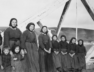Hutterite women and children at the new Springvale Colony on the bridge over the Rosebud River, March 1919, construction activity still evident. (Glenbow, NA 4079-75).